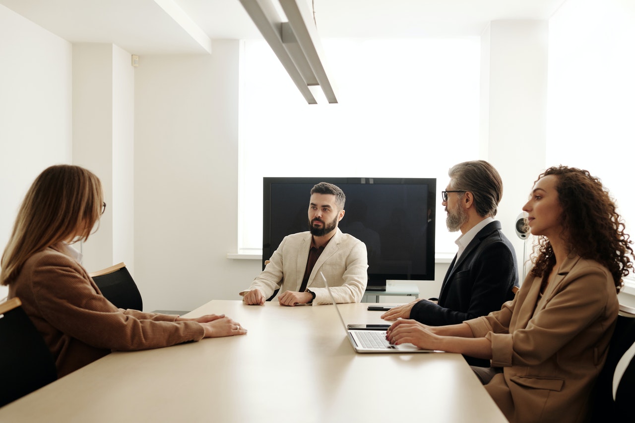 a lady is giving interview in front of job board